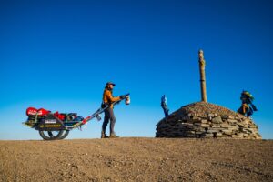 man beside cart in gobi desert