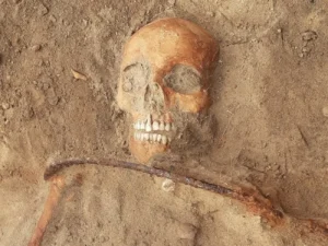 Vampire grave with a sickle across the neck.