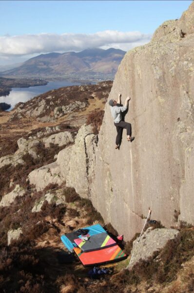 Pete Gunn climbing a boulder.