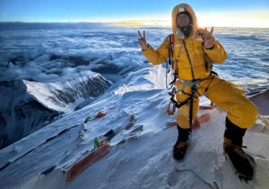 Furtenbach with victory sign on the summit of Everest at dawn