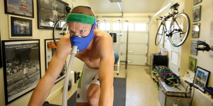 A man trains in simulated hypoxia on a bicycle. 