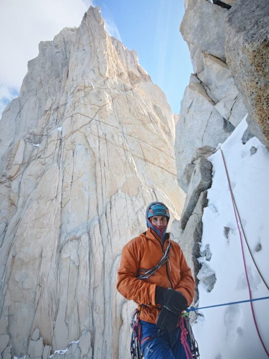 A climber at a belay, at the foot od a Patagonia wall