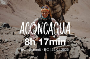 Lenka poses in front of a Condor statue, her Aconcagua speed record printed on the photo