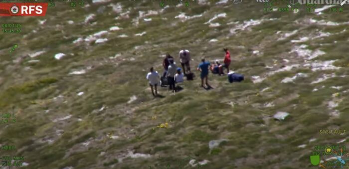 a group of hikers gathered around a lost hiker