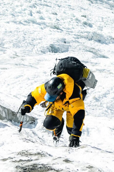 The climber on front crampon points and ice-axe. 