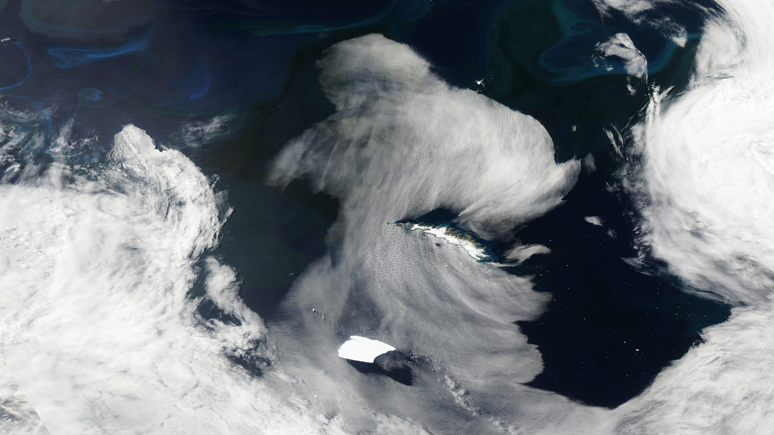 an iceberg nears an island