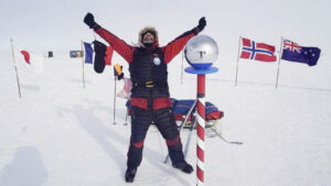 a man celebrates at the south pole