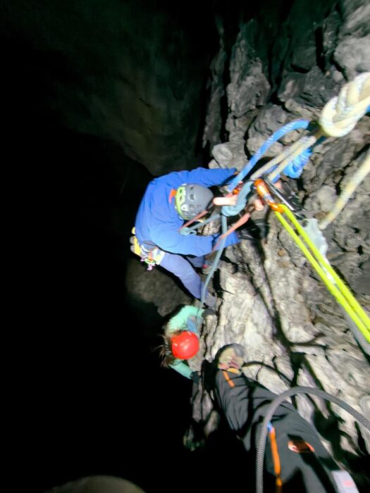 rescuers on a vertcal wall in the night. 