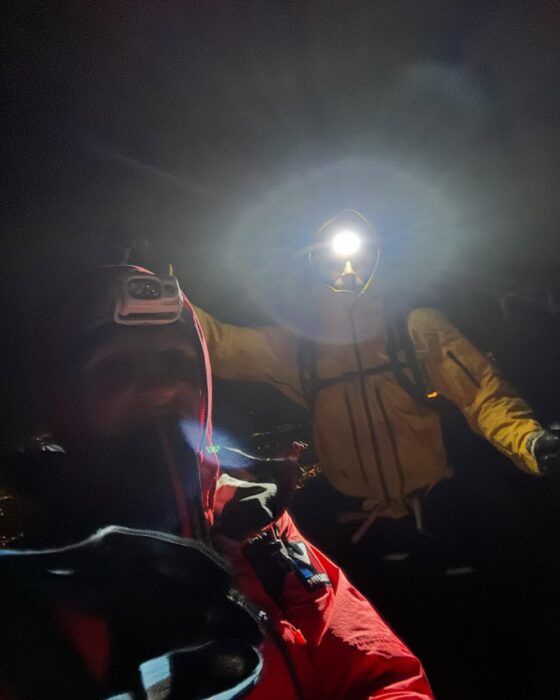 Climbers in the night with lights from headlamps