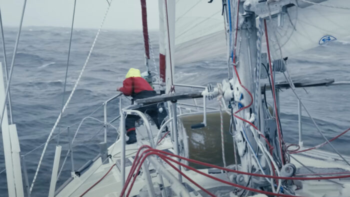 a man stands on a boat in stormy waters