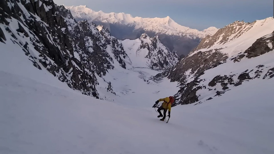 climber walking up snowy slope