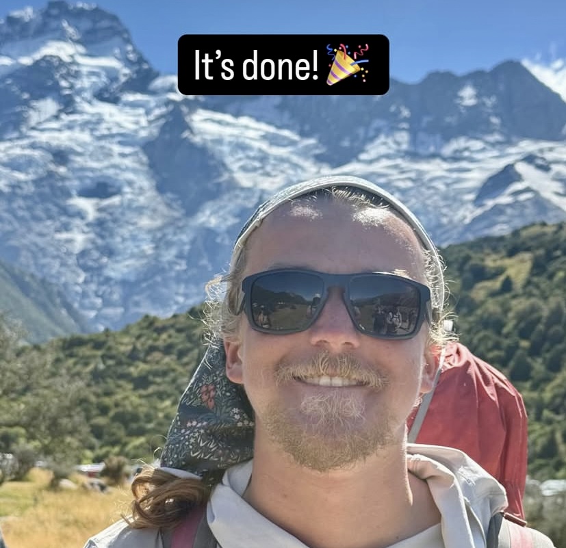 Nathan Longhurst and behind him Mt. Sefton and Mt. Footstool.