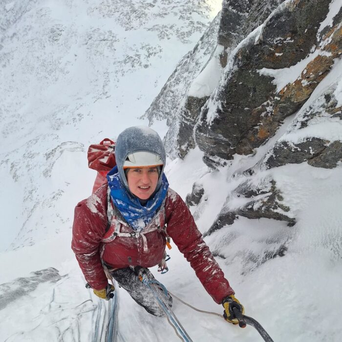 Ice climber on top of a steep goulotte