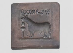 A tablet with sigils and a bull