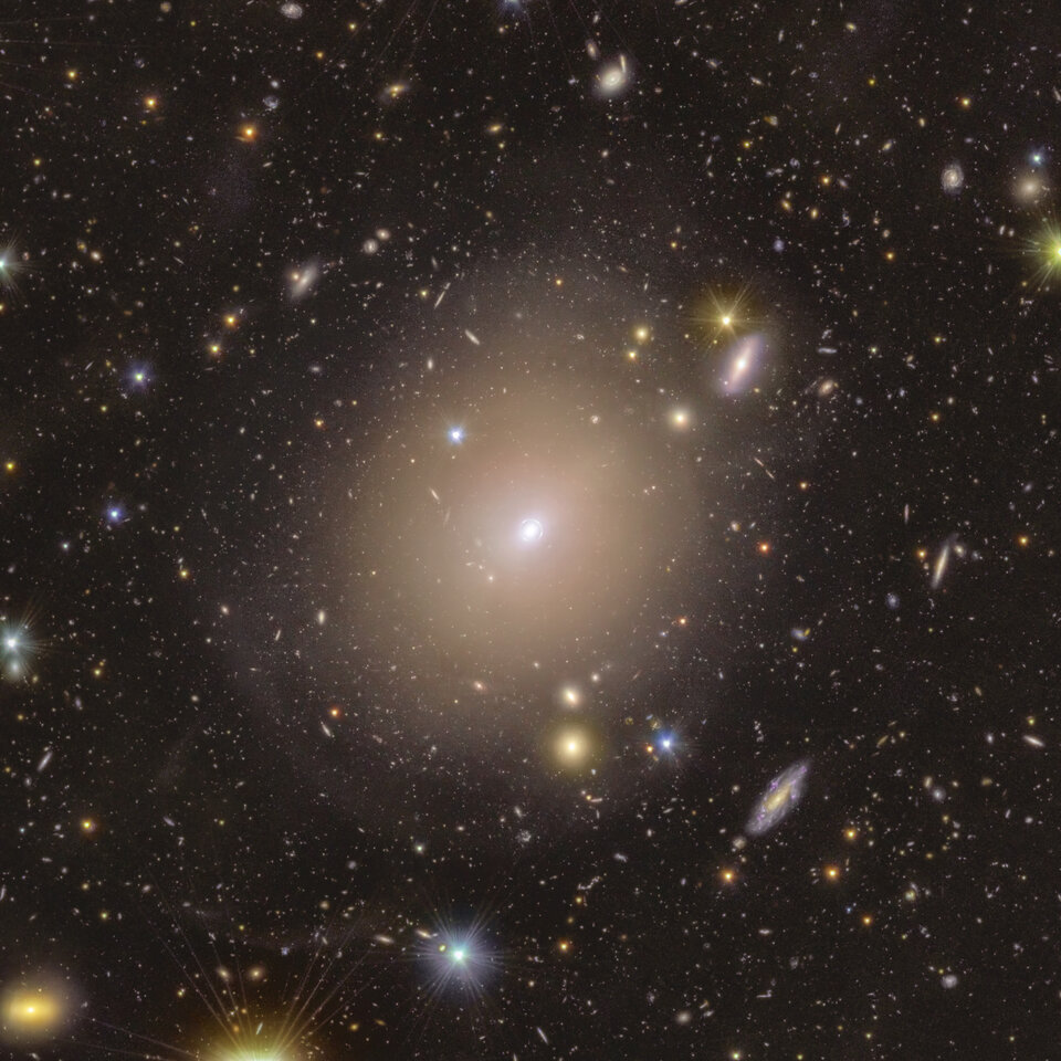 A photo of an elliptical galaxy with a lens at the center.