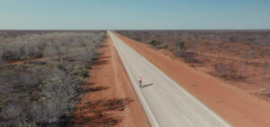 man cycling on open road