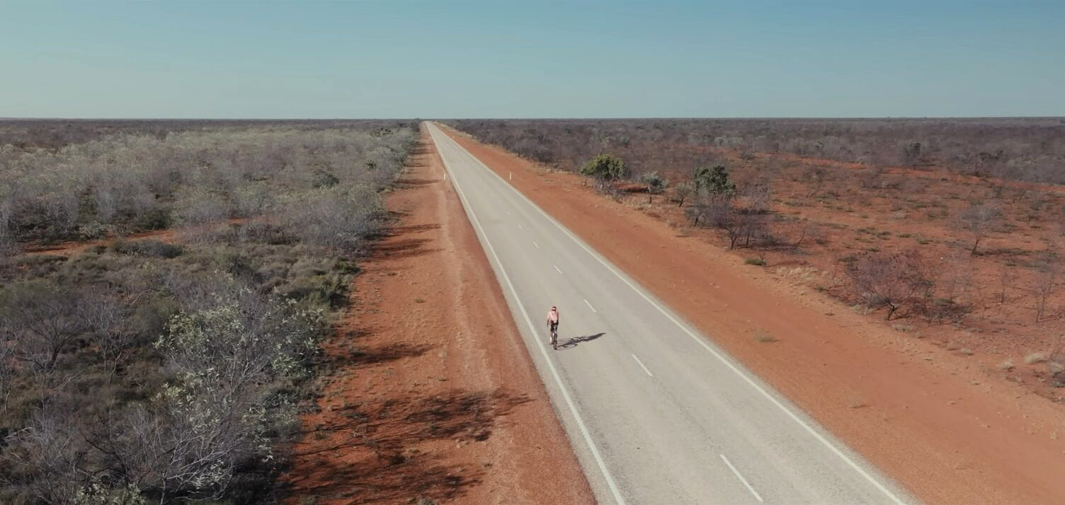 man cycling on open road