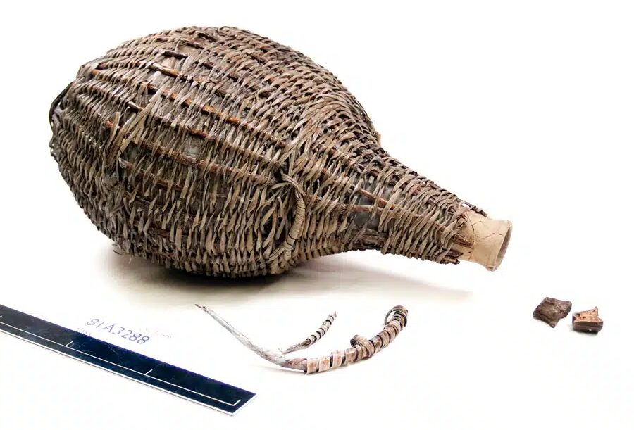 A wicker flask and ruler.