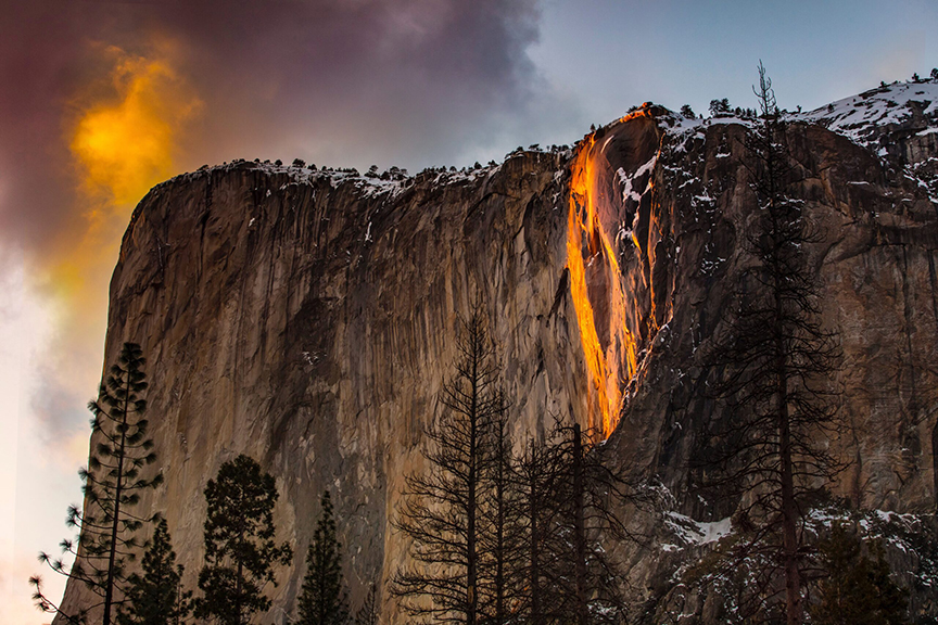 The sun hits a waterfall on El Capitan and makes it resemble a flow of fire.