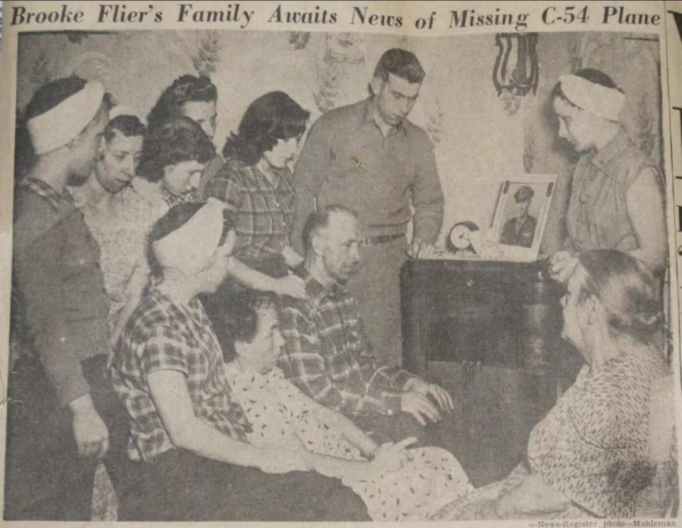 An old newspaper clipping showing several people gathered around the radio.