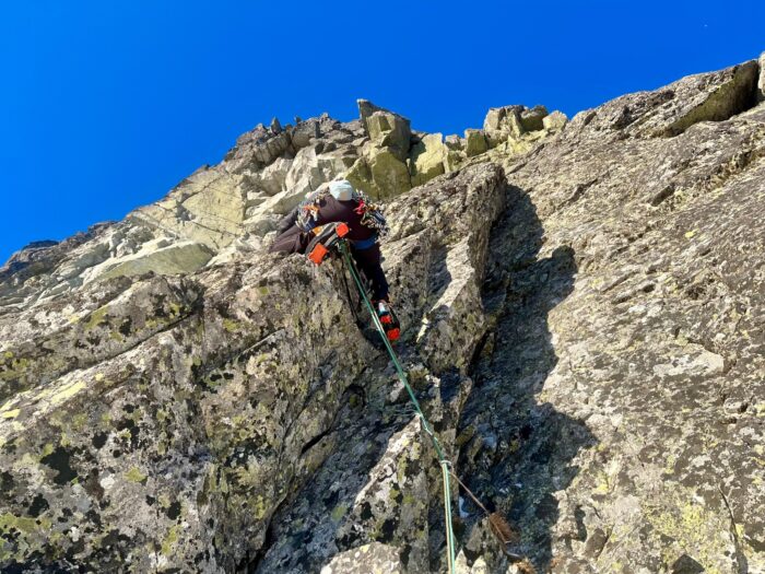 A climber on a rocky dihedral