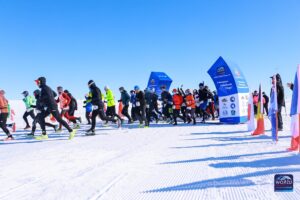 A group of runners on a field of ice.