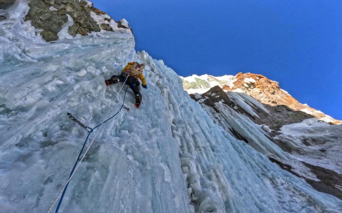 A climber on vertical water ice.