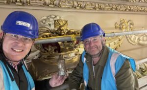 two guys in blue construction helmets