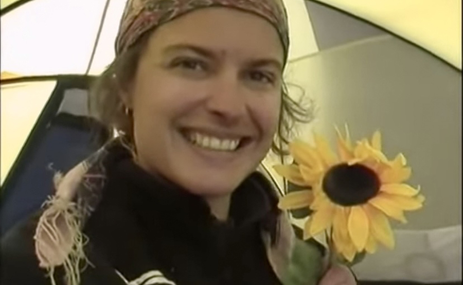 Mauduit holding a sunflower in a tent