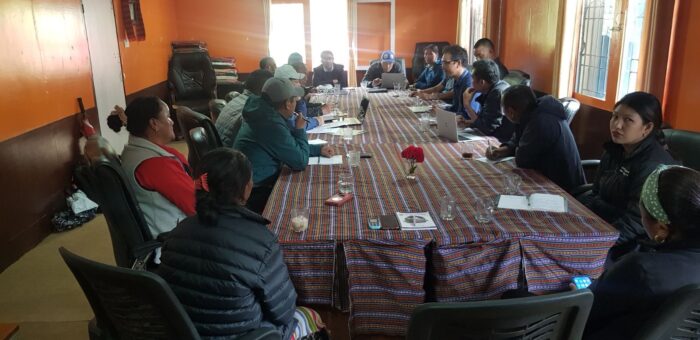 Sherpa representatives discuss enviromental issues around a big table