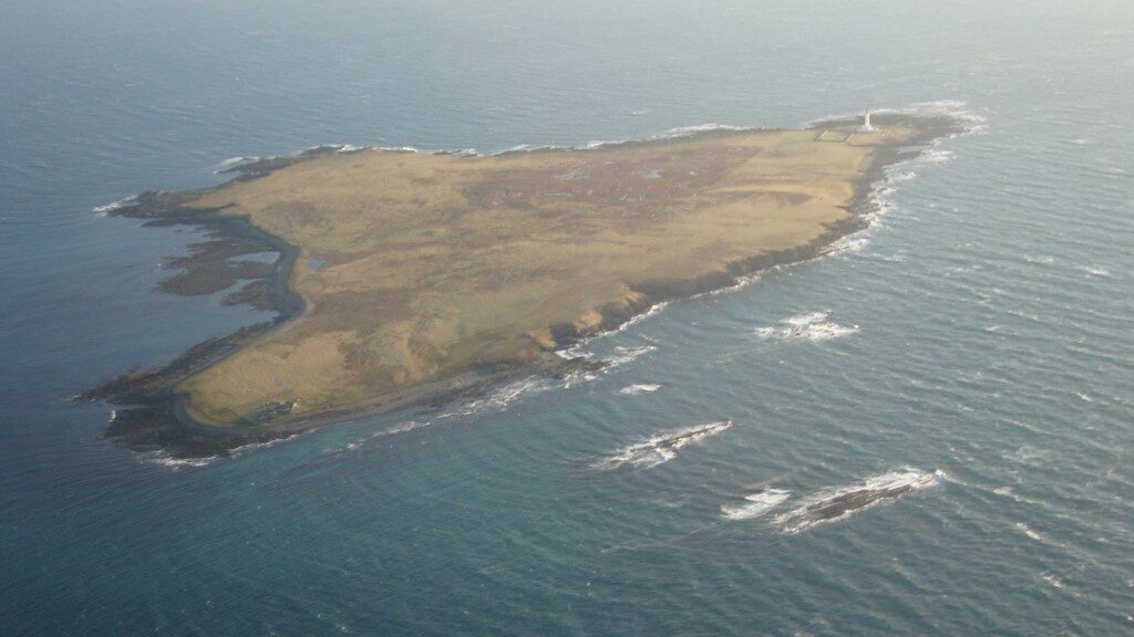 Aerial view of Auskerry, a small flat island.