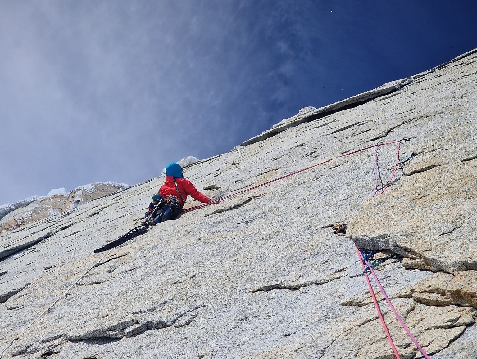 A climber on a smooth, vertical granite wall in Paragonia.