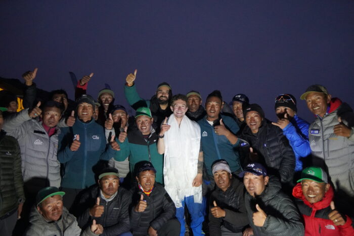 Tyler Andrews surrounded by the Asian Trekking sherpa team after his Manaslu FKT.