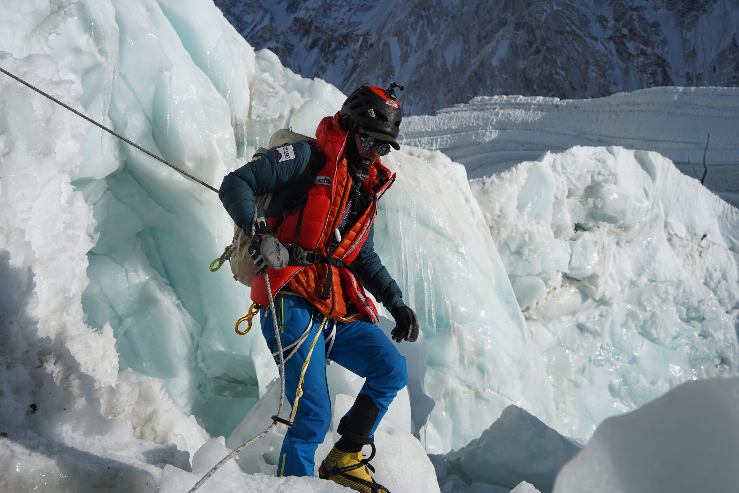 Andrews among blocks of ice at the Khumbu Icefall, holding a fixed rope.