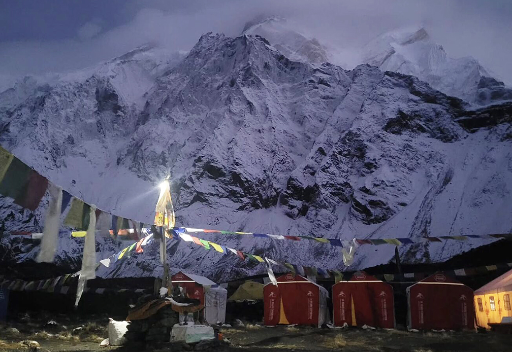 The puja chorten with a lamp on, and Annapurna behind wrapped in clouds.