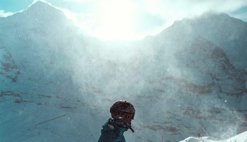 A skier in front of mountains