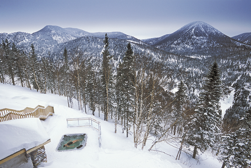 bather in hot tub in snow