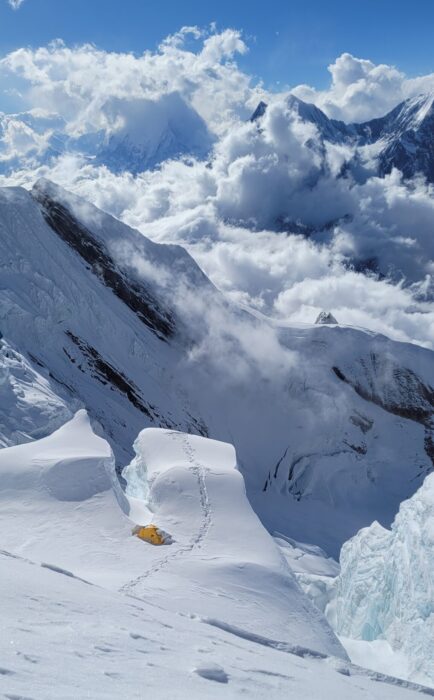 A lonely tent pitched by a hanging serac on Annapurna.