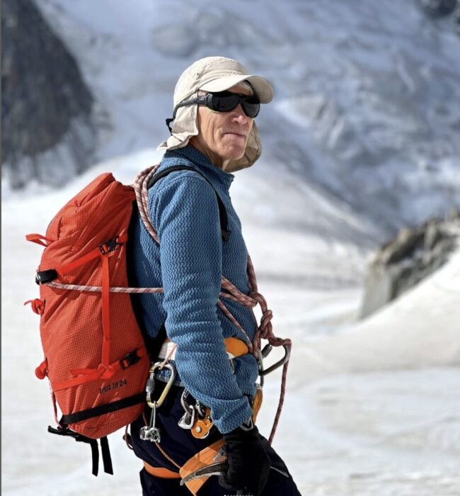 Close shot of Babanov with a mountain face behind