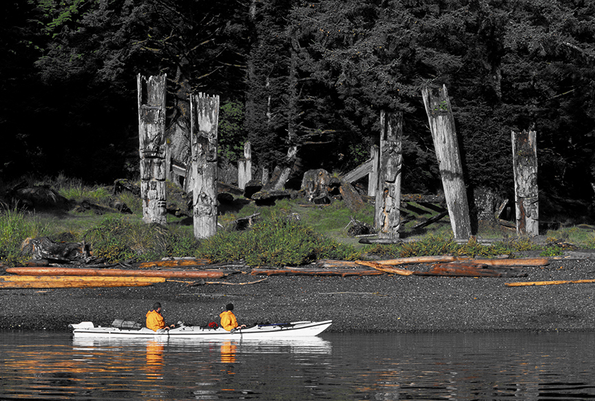 totem poles and kayakers