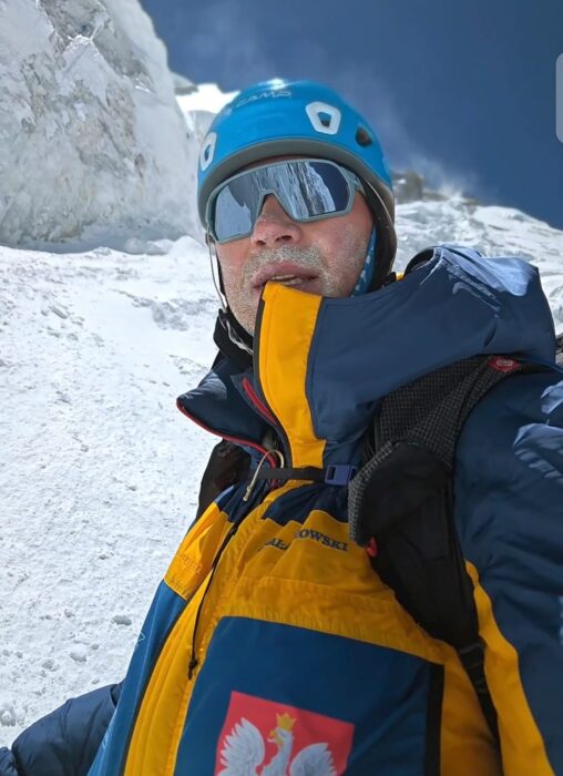 Close shot of Polish climber Piotr Krzyzowski with a helmet and sunglasses on Annapurna.