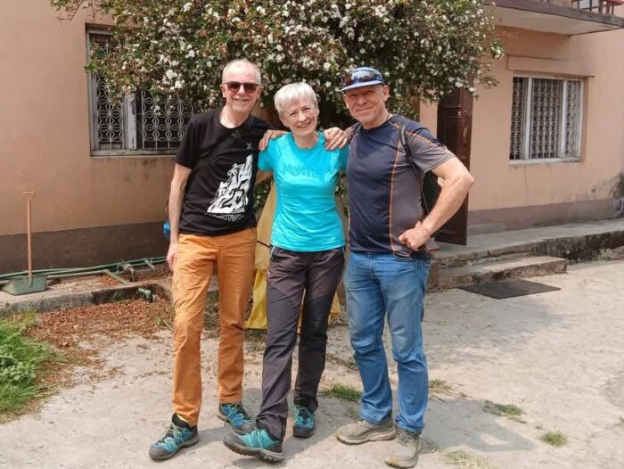 Benet, Meroi and Hamor standing up in the street in Kathmandu, dressed in t-shirts and jeans.