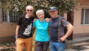 Benet, Meroi and Hamor standing up in the street in Kathmandu, dressed in t-shirts and jeans.