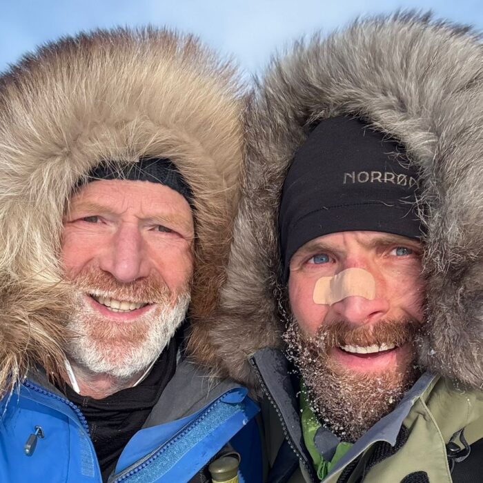 Two arctic travelers, Borge Ousland and Vincent Colliard, smiling in a selfie style photo.