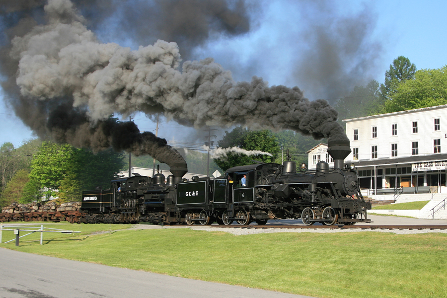 A steam train belching smoke.