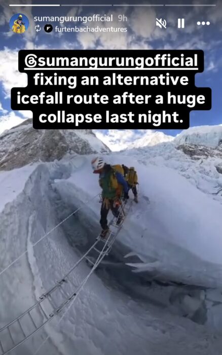 Suman Gurung crosses a crevasse on Everest on an aluminium ladder.