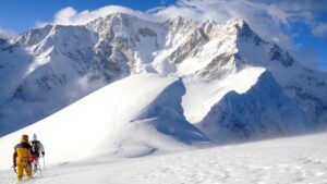 Two climbers on a lonely Himalayan snow ridge.