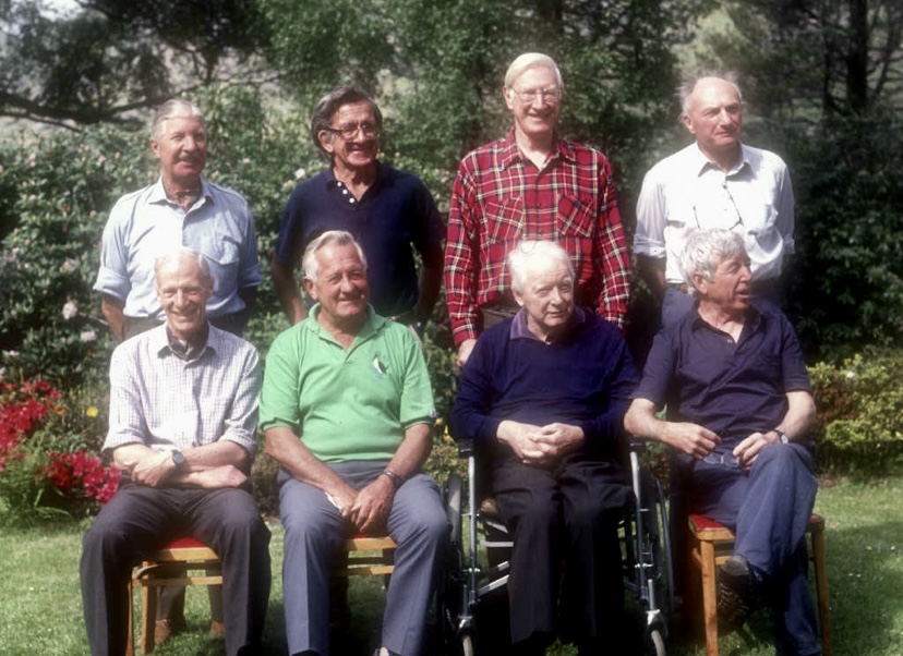 A photo of the 1990 reunion of the 1955 Kangchenjunga climbers. From left to right front: Neil Mather, John Jackson, Charles Evans and Joe Brown. Left to right rear: Tony Streather, Norman Hardie, George Band and John Clegg.