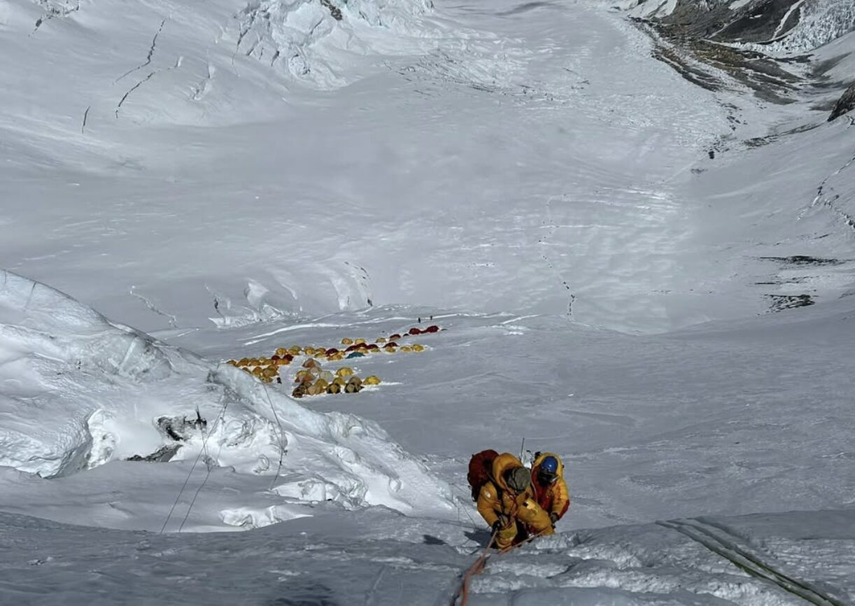 Climbers on a fixed ropes on the Lhotse Face with camp 3 tents below them, as they head for the Camp 4 of Everest.