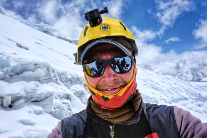 Close shot of Saulius Damulevicius with helmet and sunglasses.